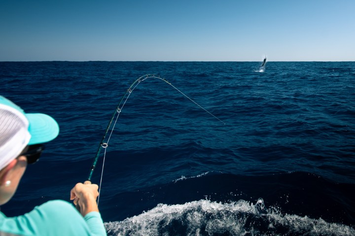 a person standing next to a body of water